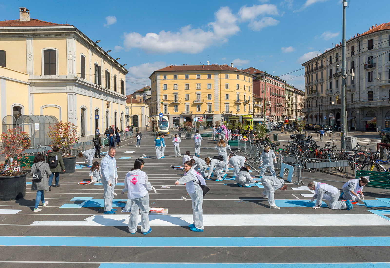 Bloomberg L.P. volunteers paint a pedestrian plaza in Milan, Italy.